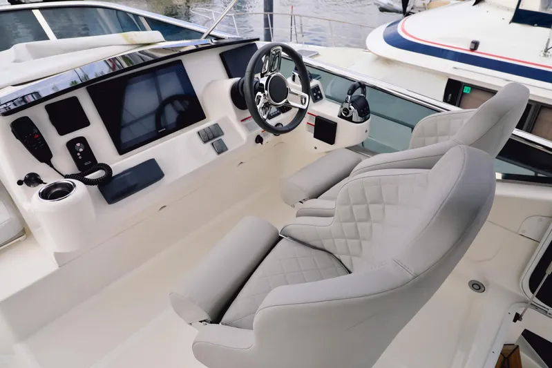 Low Key Yacht Photos Pics Luxurious helm of 2019 Absolute 50 Fly yacht with modern controls and plush seating.