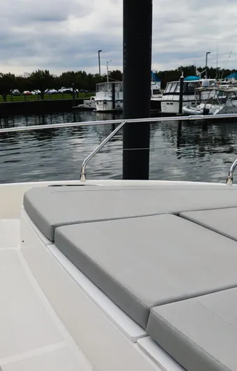 Low Key Yacht Photos Pics 2019 Absolute 50 Fly yacht with cushioned deck, docked in a marina.