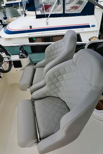 Low Key Yacht Photos Pics Luxurious seating on 2019 Absolute 50 Fly yacht with quilted gray upholstery.