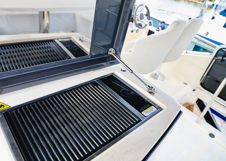 Low Key Yacht Photos Pics Outdoor grill and seating area on a 2019 Absolute 50 Fly yacht.