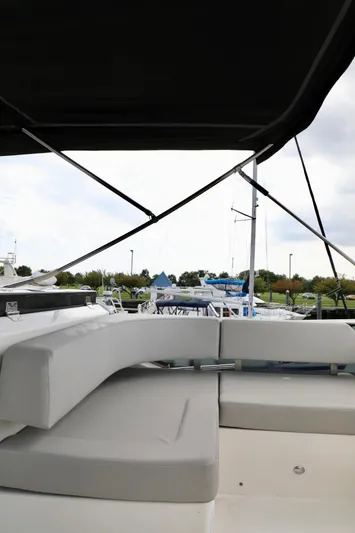 Low Key Yacht Photos Pics 2019 Absolute 50 Fly yacht with cushioned seating, docked at marina.