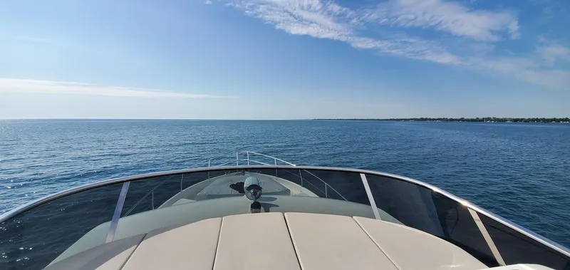 Low Key Yacht Photos Pics Bow view of 2019 Absolute 50 Fly yacht cruising on open sea under clear blue sky.