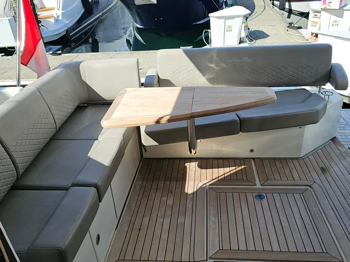 Just M Yacht Photos Pics Luxurious seating area on 2018 Sea Ray Fly 460 yacht with wooden table and cushioned seats.