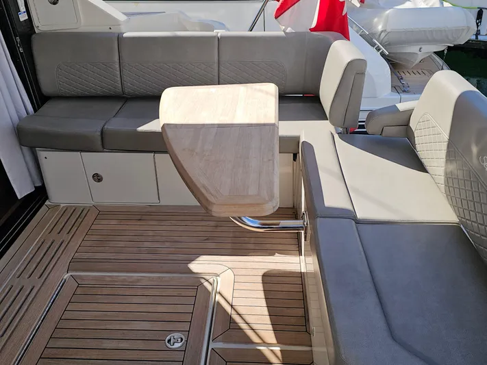 Just M Yacht Photos Pics 2018 Sea Ray Fly 460 yacht deck with cushioned seating and wooden table.