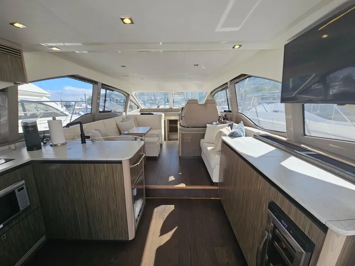 Just M Yacht Photos Pics Luxurious interior of 2018 Sea Ray Fly 460 yacht with modern amenities and panoramic windows.