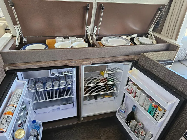 Just M Yacht Photos Pics Kitchen area of 2018 Sea Ray Fly 460 yacht with stocked fridge and dish storage.