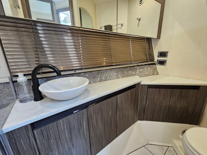 Just M Yacht Photos Pics Luxurious bathroom interior of 2018 Sea Ray Fly 460 yacht with modern sink and wood accents.