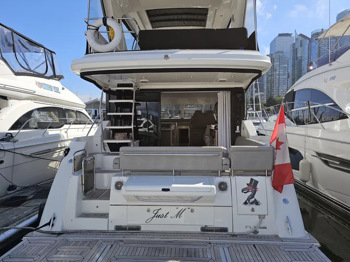 Just M Yacht Photos Pics 2018 Sea Ray Fly 460 yacht docked, featuring spacious deck and Canadian flag.