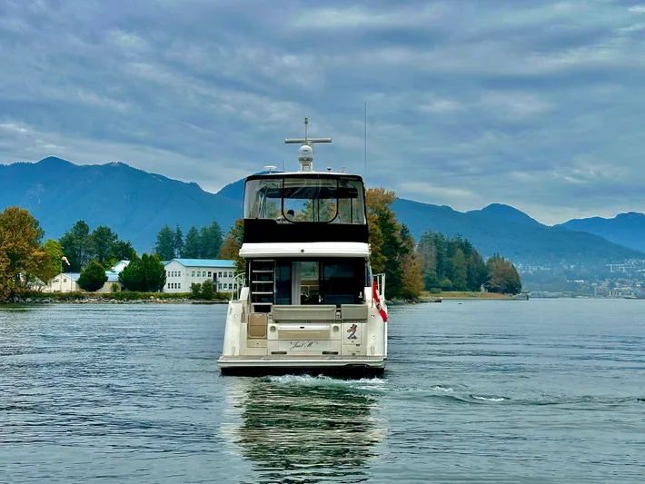 Just M Yacht Photos Pics 2018 Sea Ray Fly 460 yacht cruising on a scenic lake with mountains in the background.