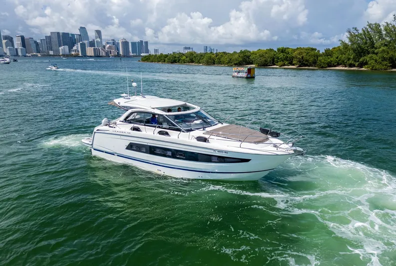  Yacht Photos Pics 2019 Jeanneau Leader 40 yacht cruising in scenic waters near a city skyline.