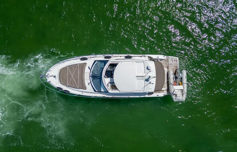  Yacht Photos Pics Aerial view of 2019 Jeanneau Leader 40 yacht cruising on green water.