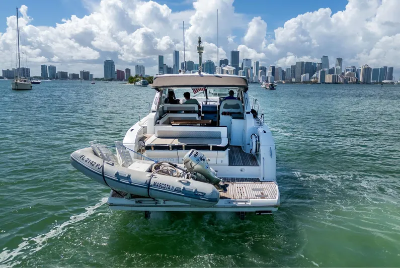  Yacht Photos Pics 2019 Jeanneau Leader 40 yacht cruising near city skyline, with inflatable boat attached.