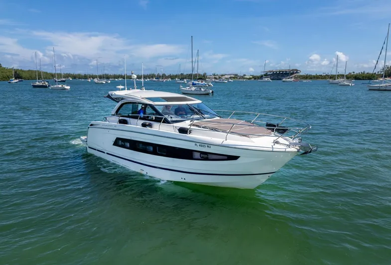  Yacht Photos Pics 2019 Jeanneau Leader 40 yacht cruising on a sunny day in a scenic harbor.