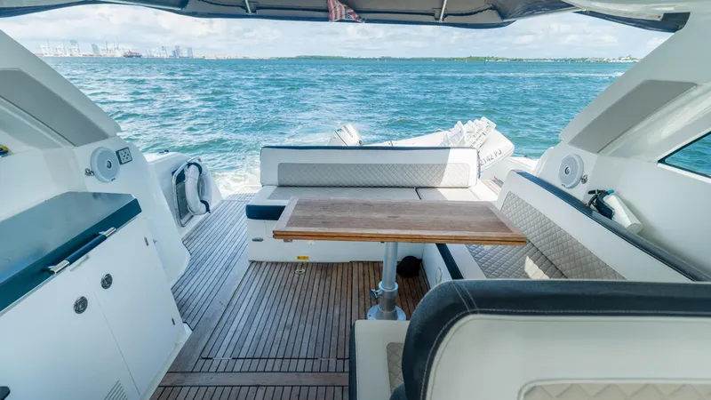  Yacht Photos Pics 2019 Jeanneau Leader 40 yacht interior with seating and table, cruising on open water.