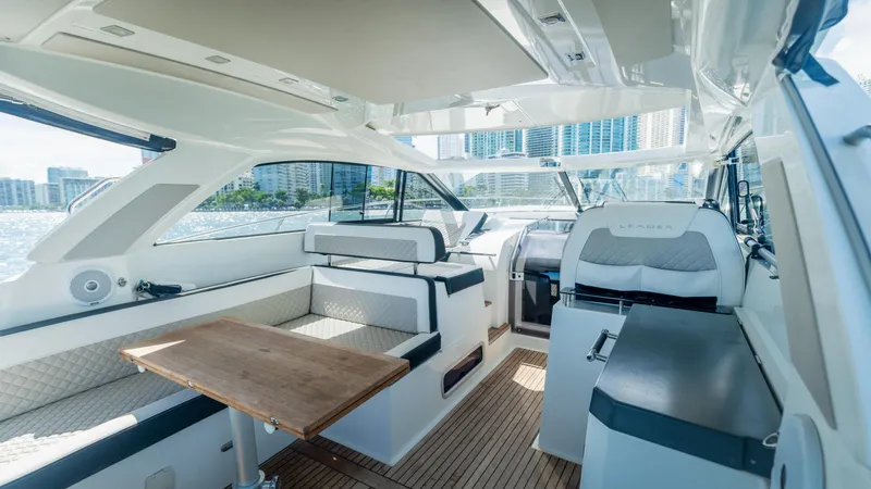  Yacht Photos Pics 2019 Jeanneau Leader 40 yacht interior with modern seating and wooden table.