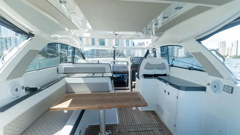  Yacht Photos Pics 2019 Jeanneau Leader 40 yacht interior with seating, table, and cityscape view.