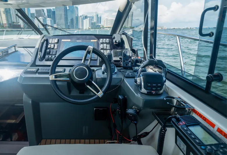  Yacht Photos Pics Helm of 2019 Jeanneau Leader 40 yacht with city skyline view.