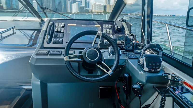  Yacht Photos Pics Helm of 2019 Jeanneau Leader 40 yacht with city skyline in background.