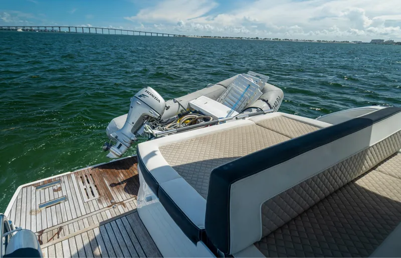  Yacht Photos Pics 2019 Jeanneau Leader 40 yacht with tender on water, featuring spacious deck and scenic view.