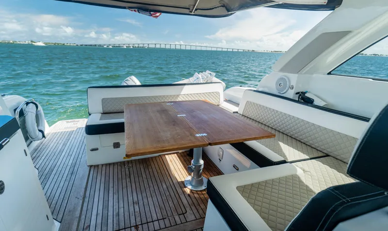  Yacht Photos Pics 2019 Jeanneau Leader 40 yacht interior with elegant seating and wooden table on open water.