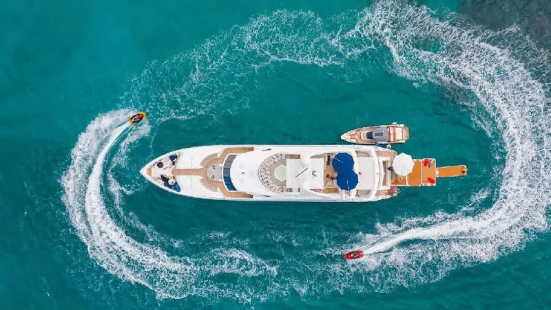 Mercy Yacht Photos Pics Aerial view of 2009 Sunseeker 37 Metre Yacht with jet skis in turquoise water.