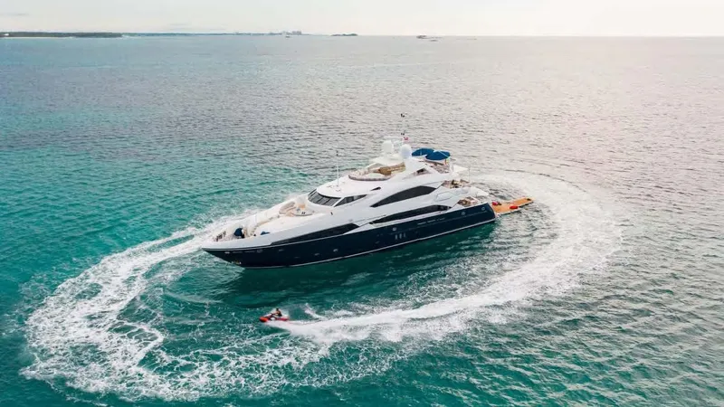 Mercy Yacht Photos Pics Luxurious 2009 Sunseeker 37 Metre Yacht cruising with jet ski in turquoise waters.