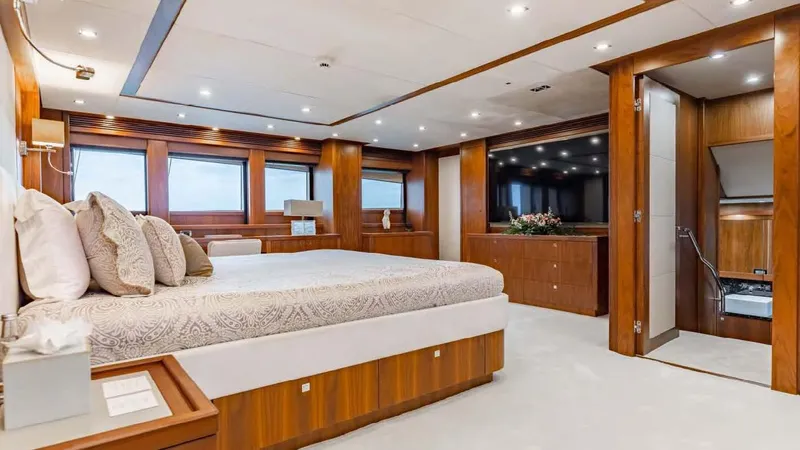 Mercy Yacht Photos Pics Luxurious bedroom interior on 2009 Sunseeker 37 Metre Yacht with wood accents and large windows.