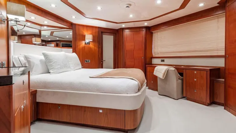 Mercy Yacht Photos Pics Luxurious bedroom interior on a 2009 Sunseeker 37 Metre Yacht with elegant wood finishes.