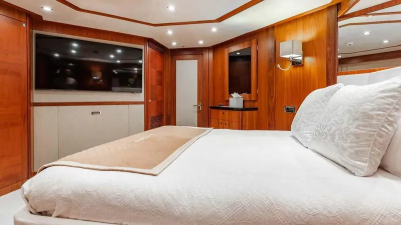 Mercy Yacht Photos Pics Luxurious bedroom interior on 2009 Sunseeker 37 Metre Yacht with wood paneling and large TV.
