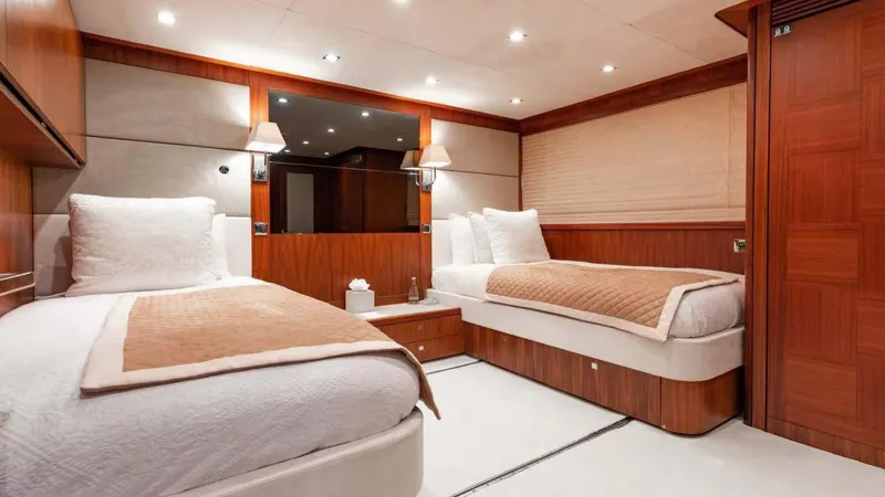 Mercy Yacht Photos Pics Luxurious twin bedroom on 2009 Sunseeker 37 Metre Yacht with elegant wood paneling.