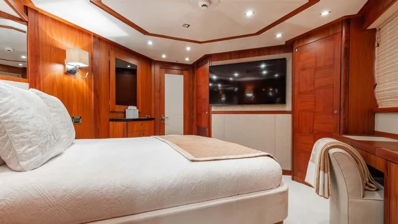 Mercy Yacht Photos Pics Luxurious bedroom interior on a 2009 Sunseeker 37 Metre Yacht, featuring elegant wood paneling.