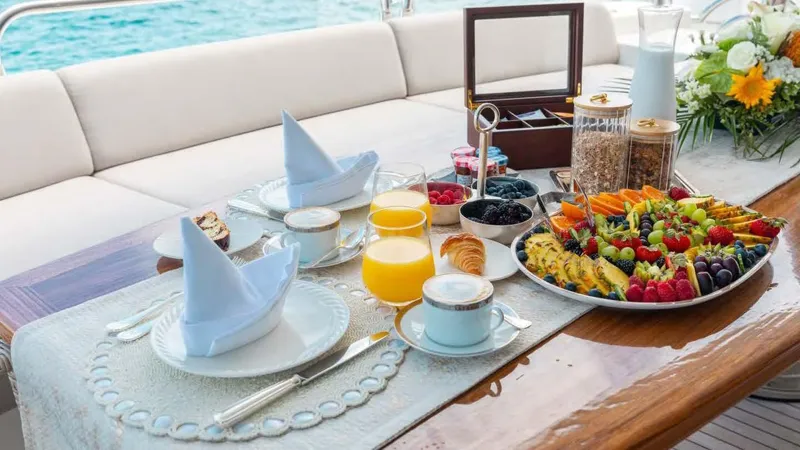 Mercy Yacht Photos Pics Luxurious breakfast setup on a 2009 Sunseeker 37 Metre Yacht, featuring fresh fruits and beverages.