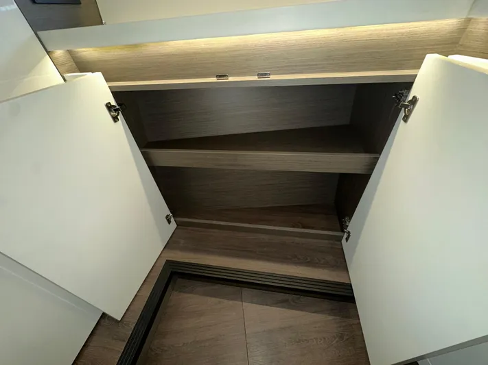 Gran Turismo 45 Yacht Photos Pics Open cabinet with shelves inside a 2023 Beneteau Gran Turismo 45 yacht interior.
