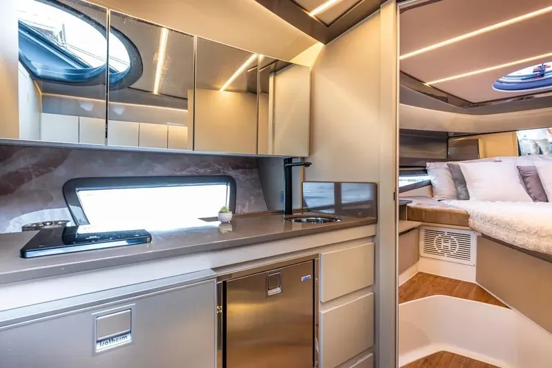  Yacht Photos Pics Luxurious interior of 2026 Hanover 415 Ultimate Luxury yacht with modern kitchen and cozy bedroom.