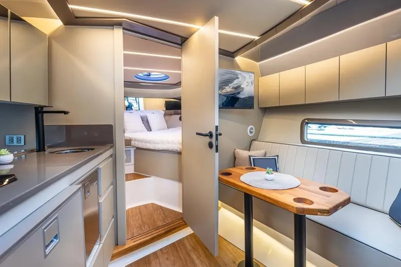  Yacht Photos Pics Luxurious interior of 2026 Hanover 415 Ultimate Luxury yacht with modern kitchen and cozy seating area.