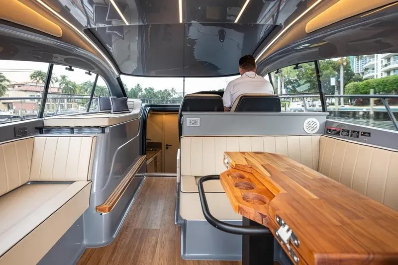  Yacht Photos Pics Luxurious interior of 2026 Hanover 415 Ultimate Luxury yacht with elegant seating and wooden table.