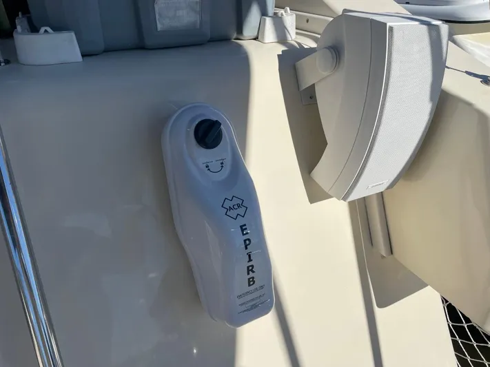 Nowhere Fast Yacht Photos Pics EPIRB device on 2005 Mainship 430 Aft Cabin Trawler, mounted near a speaker.