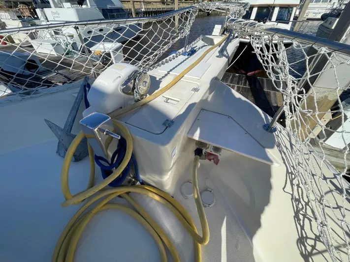 Nowhere Fast Yacht Photos Pics 2005 Mainship 430 Aft Cabin Trawler deck with ropes and anchor, docked at marina.