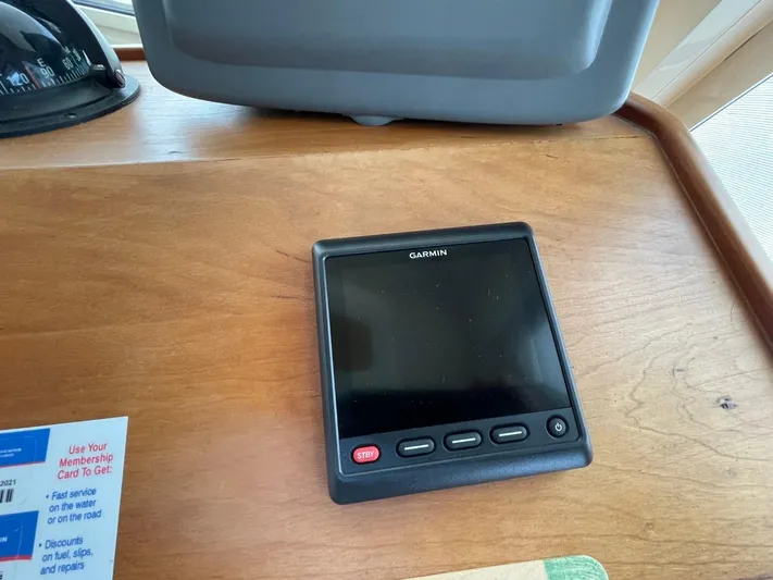 Nowhere Fast Yacht Photos Pics Garmin device on Mainship 430 Aft Cabin 3SR Trawler, 2005 model, wooden surface.