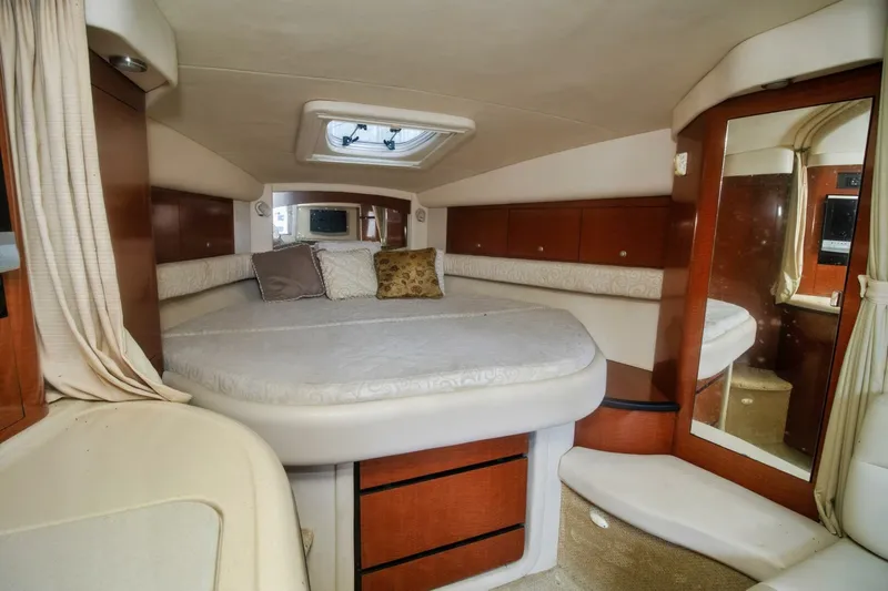  Yacht Photos Pics Interior cabin of 2005 Sea Ray 340 Sundancer yacht with bed and mirror.
