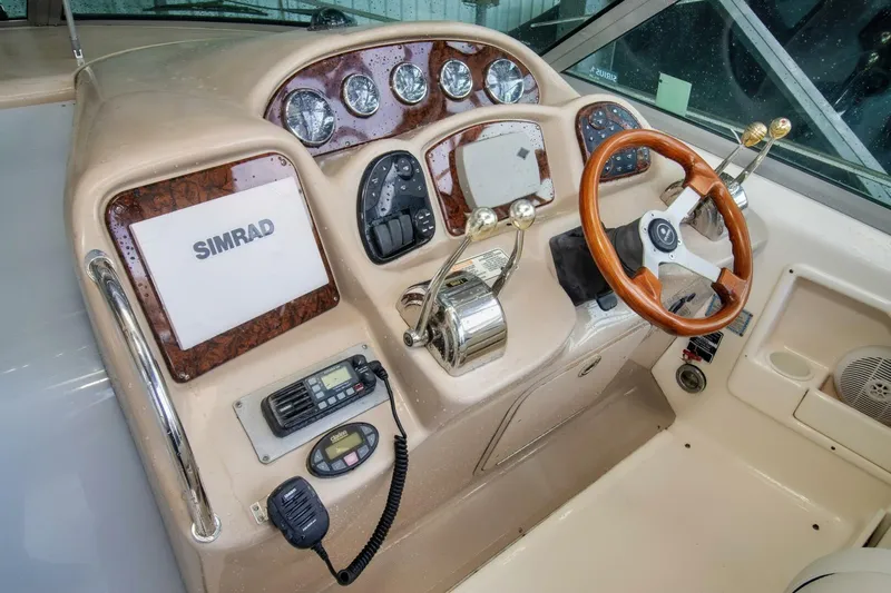  Yacht Photos Pics 2005 Sea Ray 340 Sundancer helm with Simrad navigation and wood-accented steering wheel.