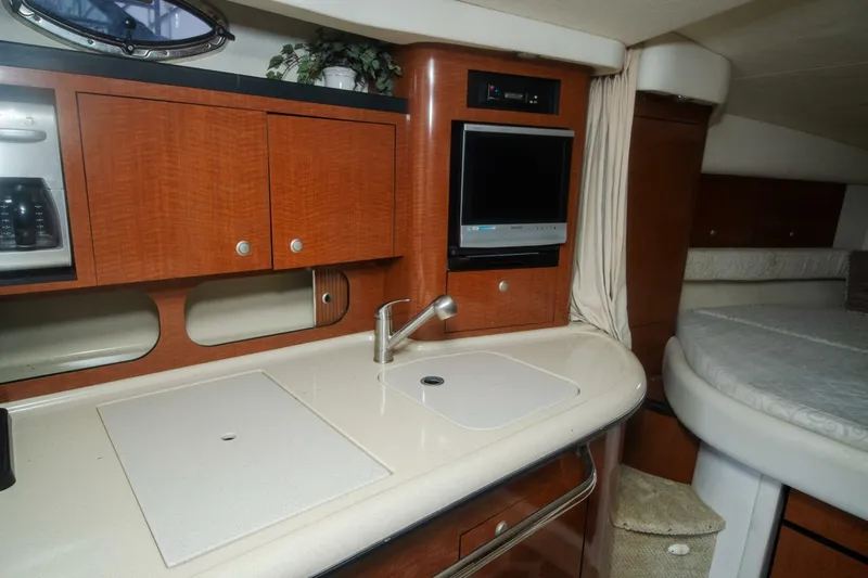  Yacht Photos Pics 2005 Sea Ray 340 Sundancer interior with kitchenette and bed.