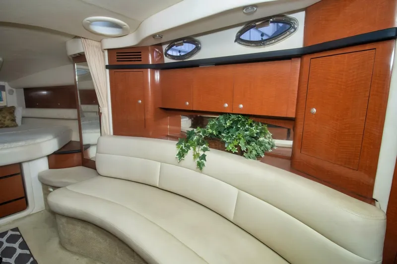  Yacht Photos Pics Luxurious interior of 2005 Sea Ray 340 Sundancer with curved seating and wood cabinetry.