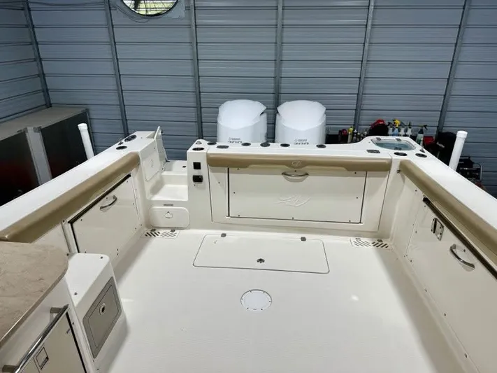  Yacht Photos Pics 2018 Sailfish 325 DC boat interior with dual engines in a storage facility.