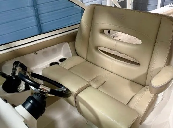  Yacht Photos Pics 2018 Sailfish 325 DC boat interior with beige leather seating and steering wheel.