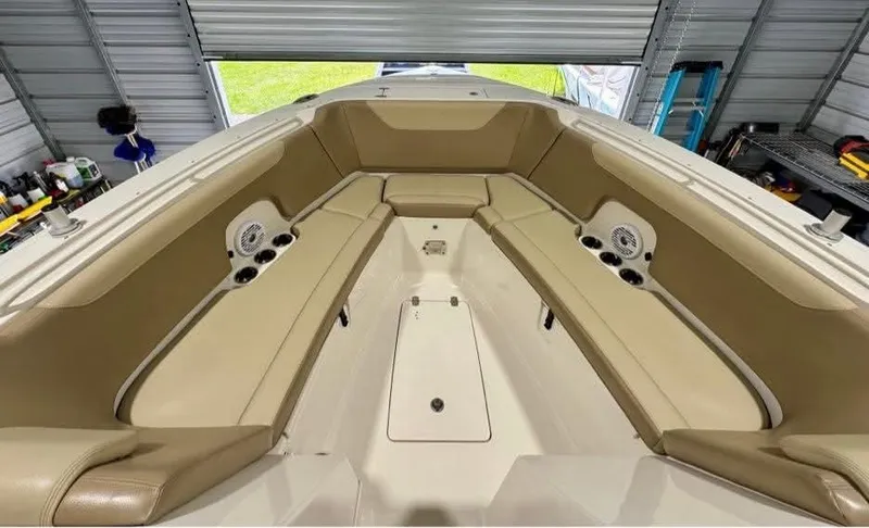 Yacht Photos Pics 2018 Sailfish 325 DC boat interior with tan seating and speakers in a garage.