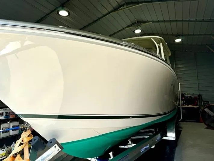  Yacht Photos Pics 2018 Sailfish 325 DC boat in a well-lit indoor storage facility.