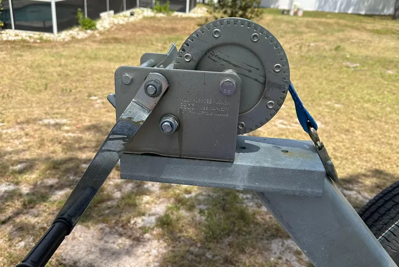  Yacht Photos Pics Boat trailer winch mechanism on a 2018 Sailfish 325 DC, parked on grass.