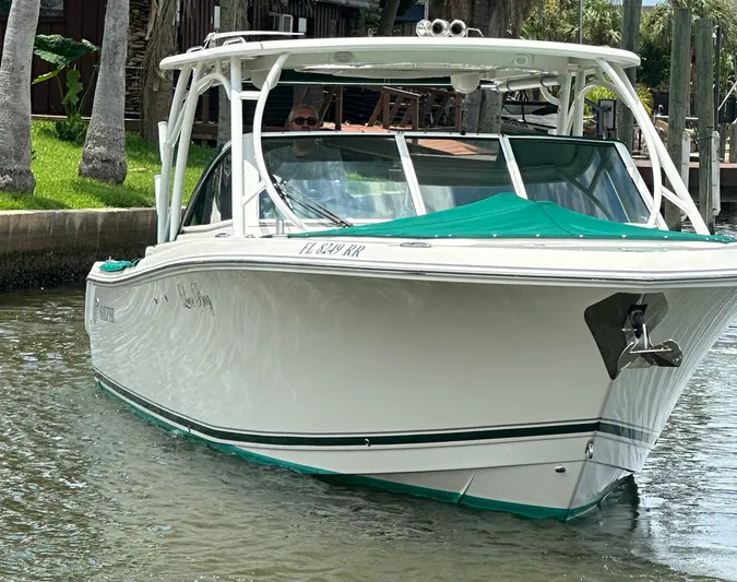 Yacht Photos Pics 2018 Sailfish 325 DC boat docked in a scenic waterfront setting.