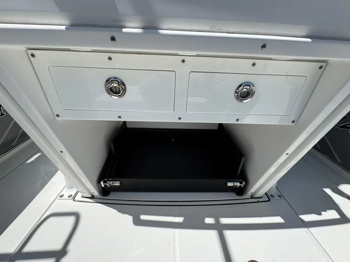  Yacht Photos Pics 2021 Blackfin 272 CC boat storage compartment with two drawers and open shelf.